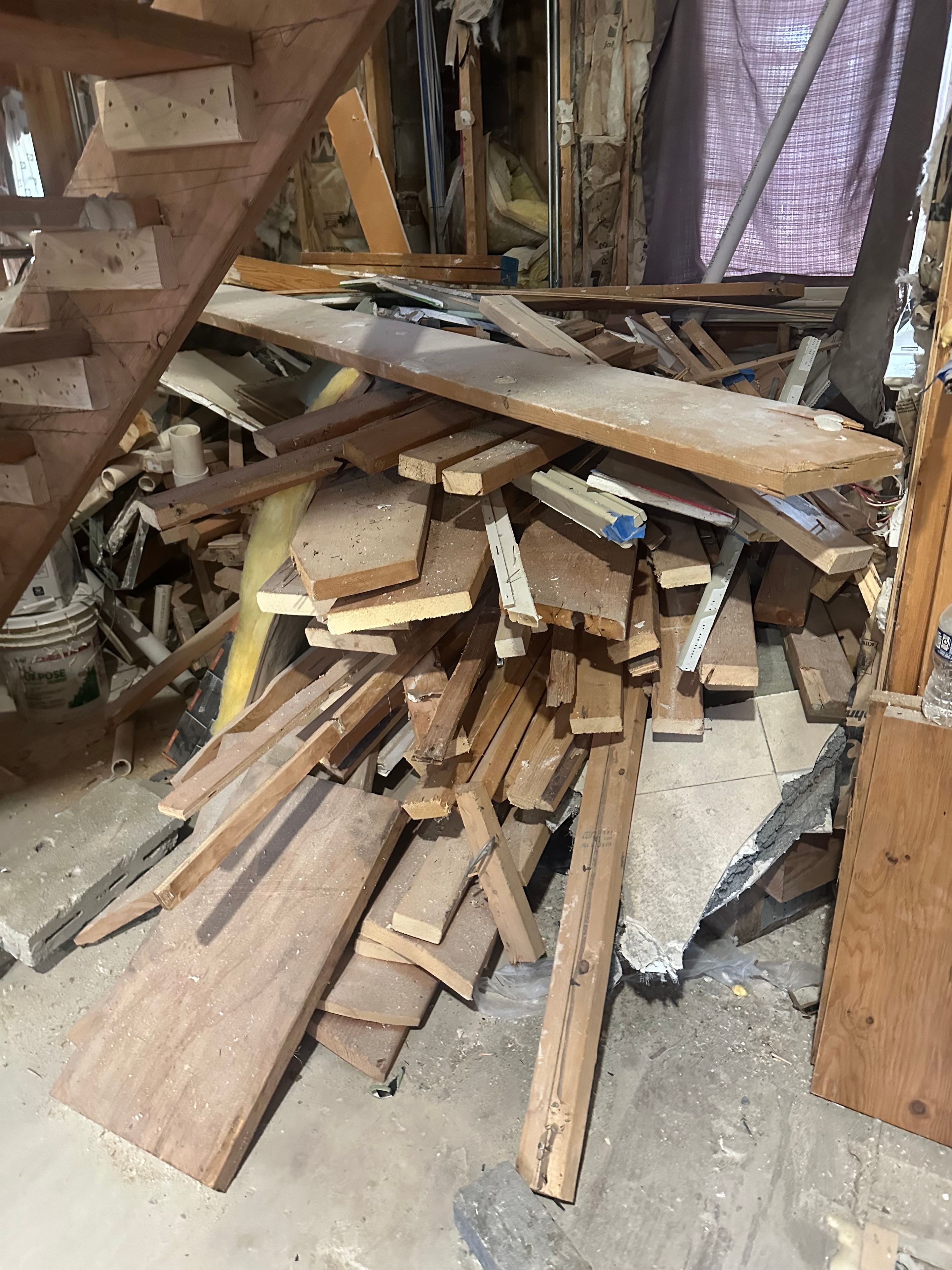 Construction debris — wood scraps and demolition materials piled on floor